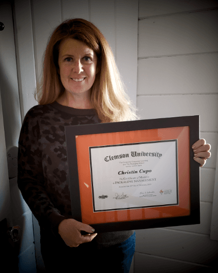 Certificate of Mastery graduate holding their framed Clemson certificate